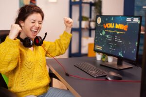 joyful player celebrates victory winning space shooter online video game powerful personal computer